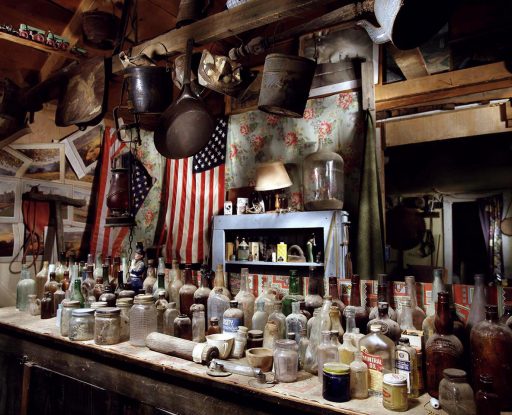 Bottle collection and american flag in the Gost town of Gold Point In Nevada