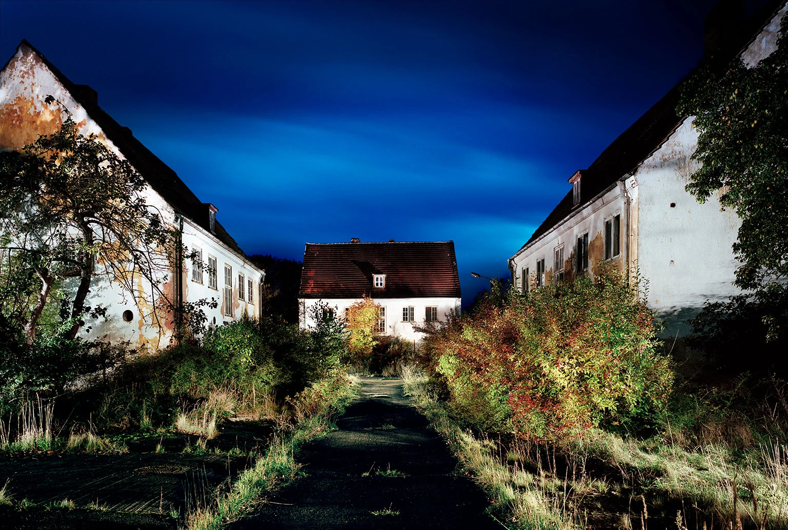 An abandoned house in the garden city of Wustrow, with an overgrown garden and old fruit trees